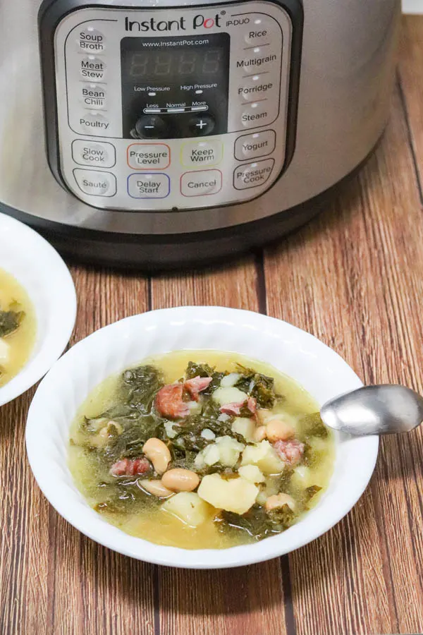 soup in a bowl with a spoon in front of the instant pot