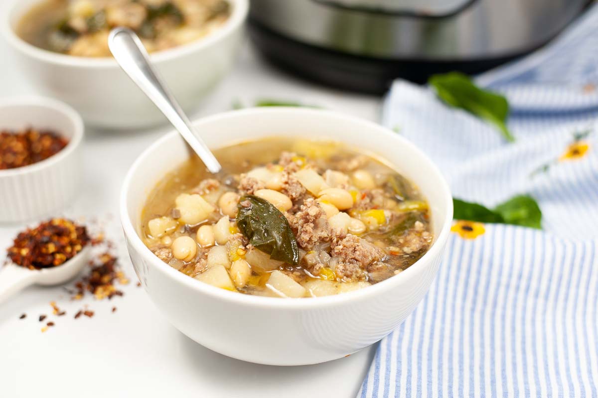 bowl of sausage potato spinach soup.