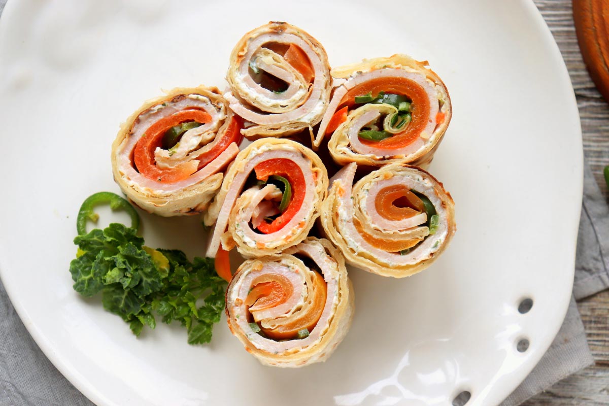 turkey roll ups on a plate.