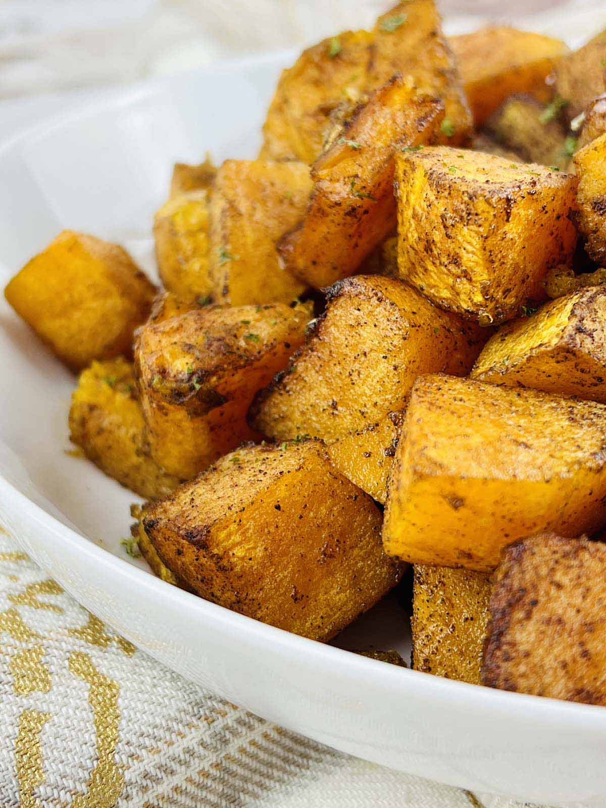 Cubed squash in a white bowl.