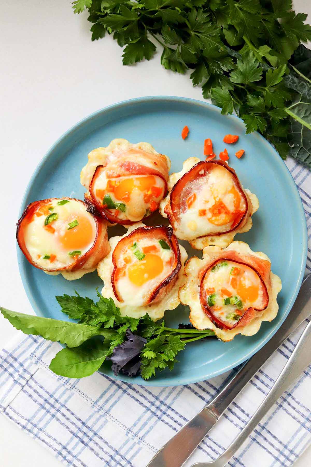 Egg cups on a plate garnished with lettuce.