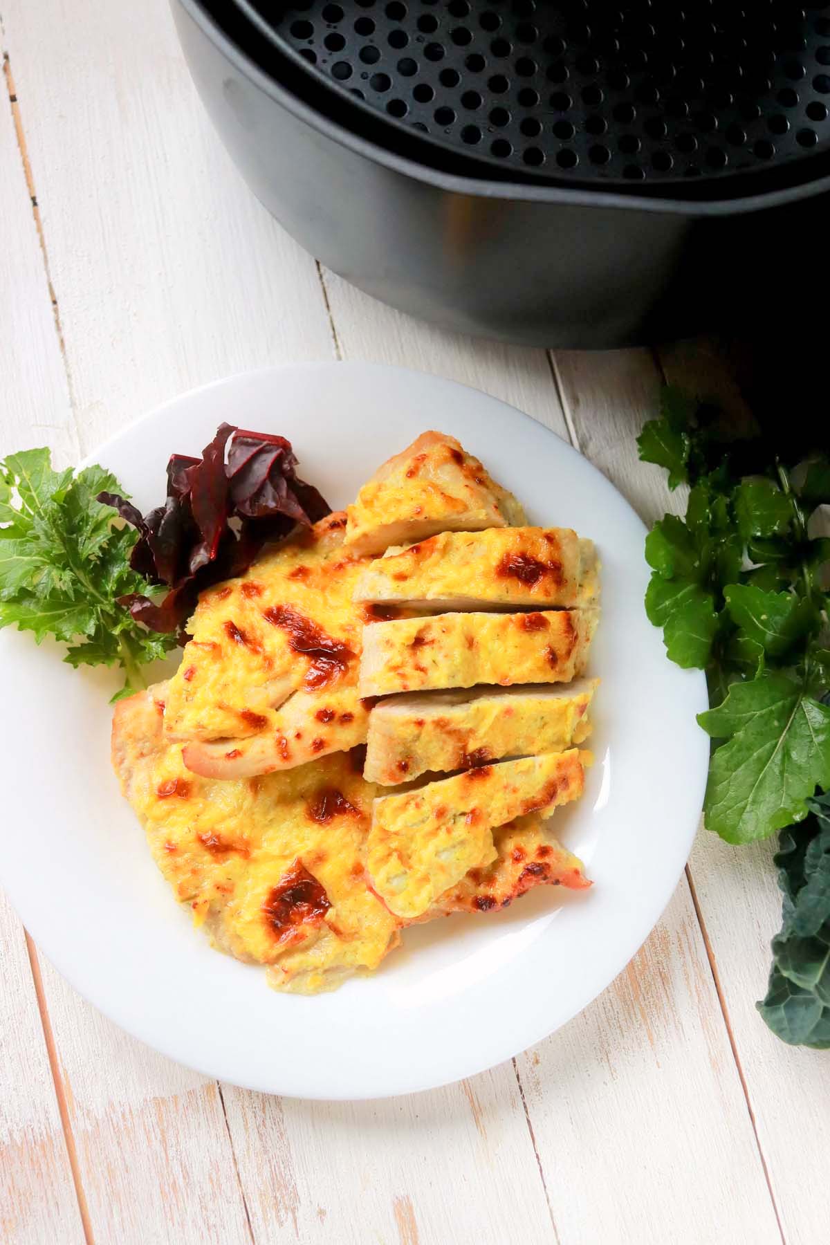 Chicken on a plate garnished with lettuce.