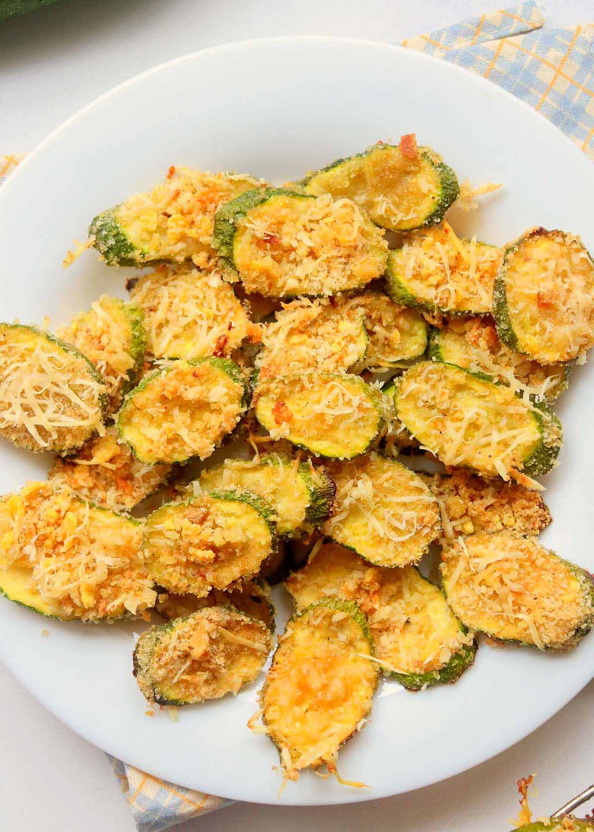 Zucchini chips on a white plate.