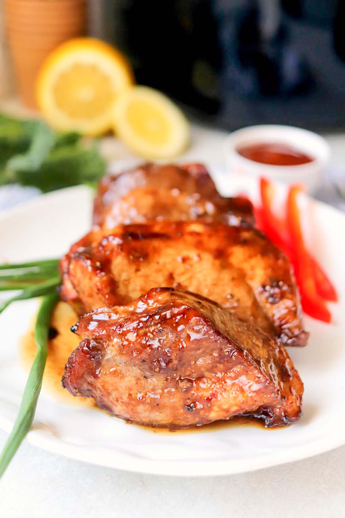 Pork chops on a white plate.