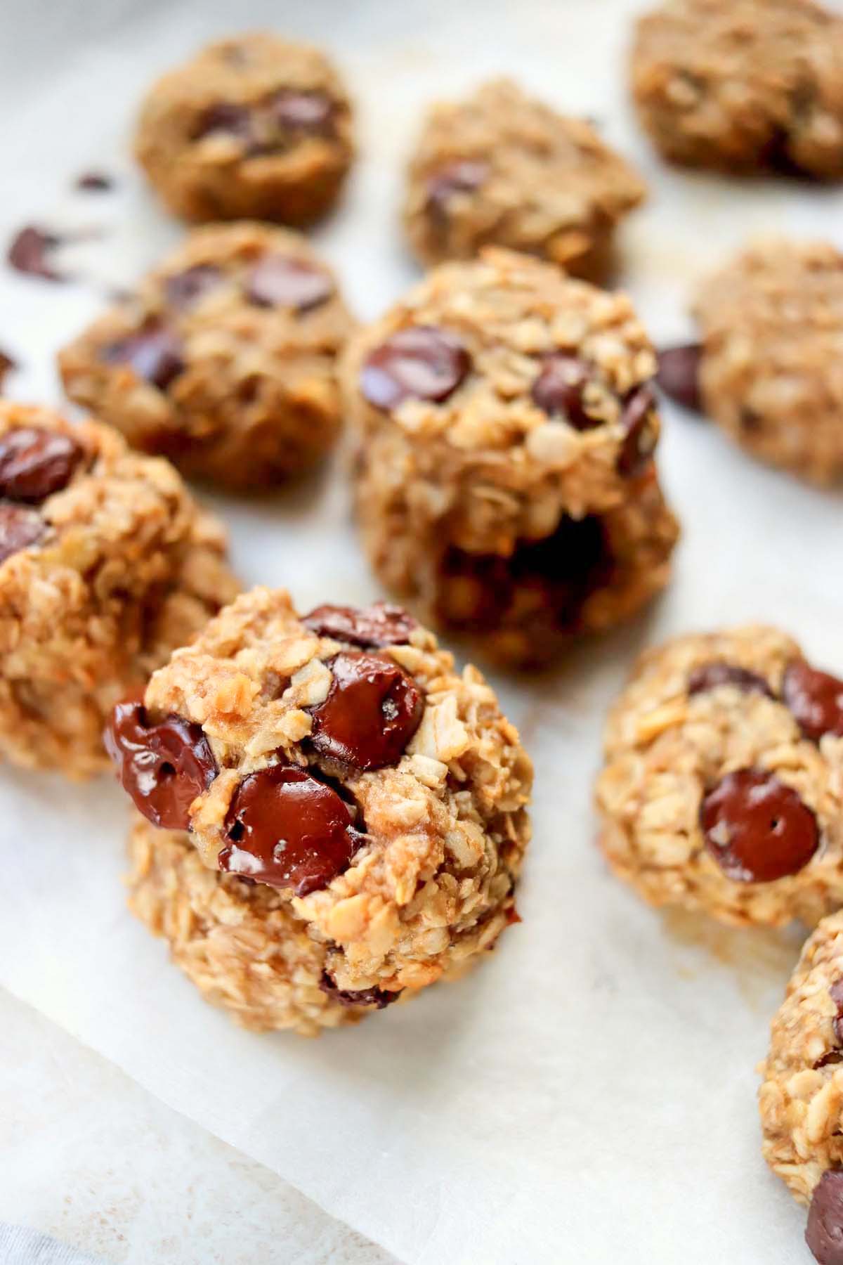 Cookies stacked on parchment paper.