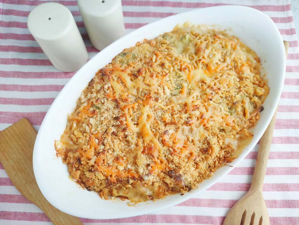 Baked casserole in a dish set on a pink and white kitchen towel.