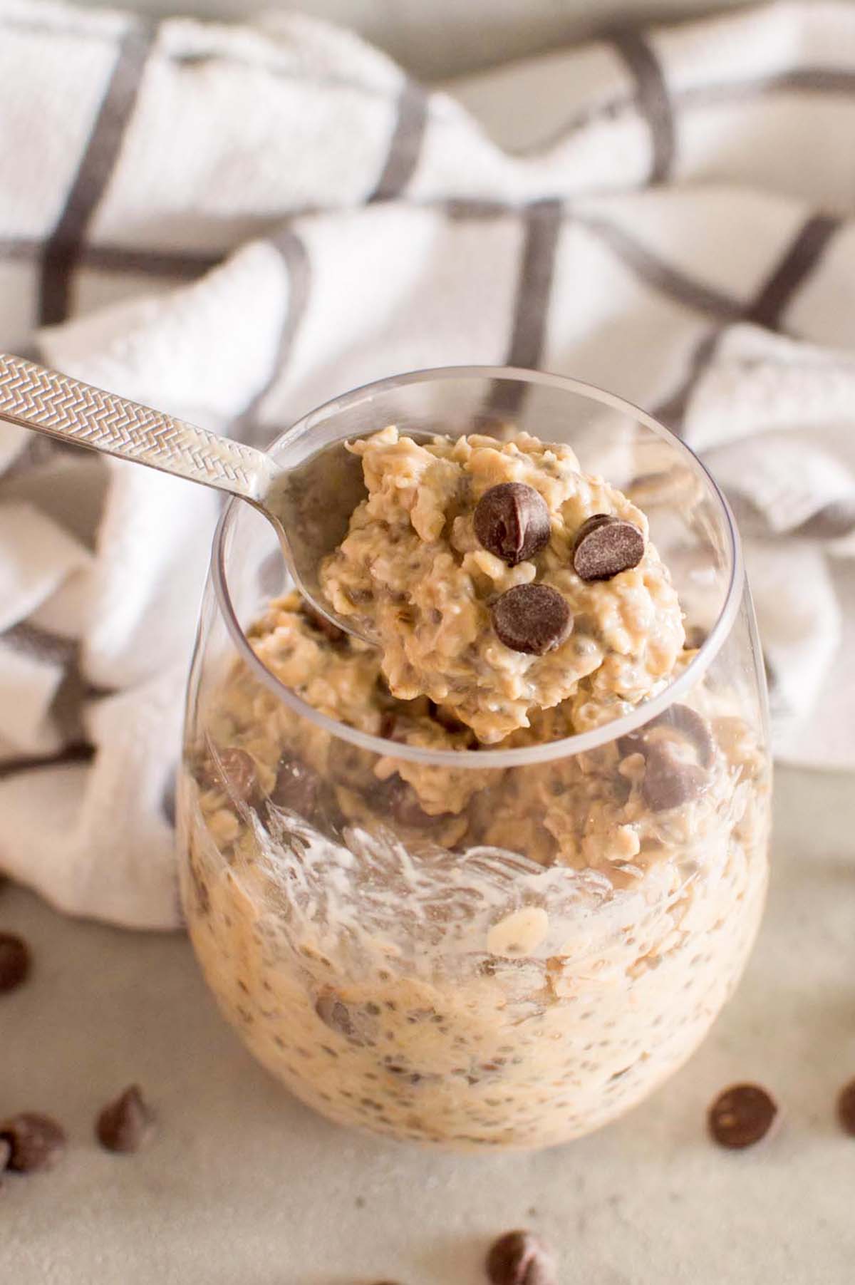 Oats scooped on a spoon topped with chocolate chips.