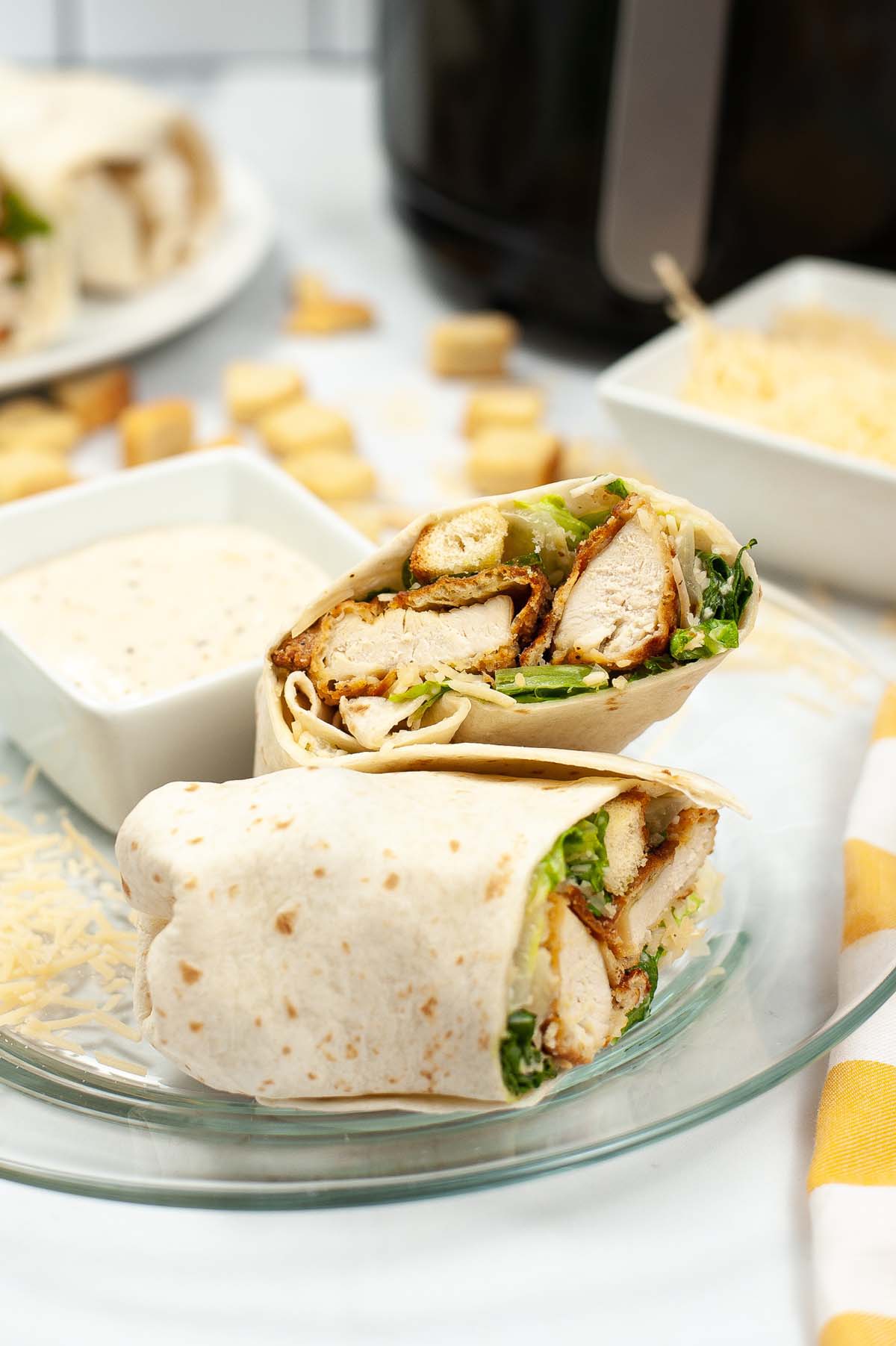 chicken wrap with caesar dressing on a plate.