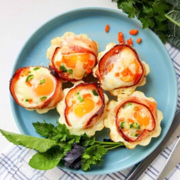 top view plate of bacon and egg cups.