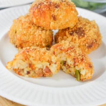 rice balls stacked on a plate with one cut in half.