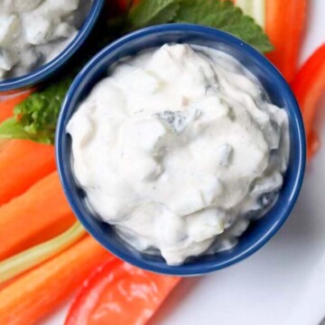 top view of dip on a plate with vegetables.