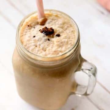 Chocolate shake in a jar with a straw.