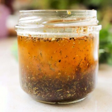 dressing with herbs in a jar.