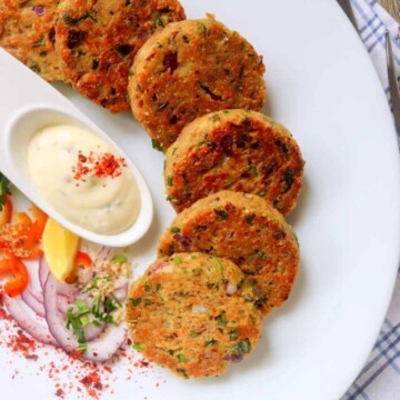 tuna patties on a plate with sauce.
