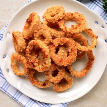 baked onion rings on a plate.