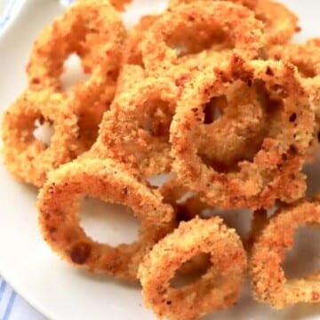 Onion rings on a white plate.