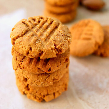 peanut butter cookies stacked on a table.