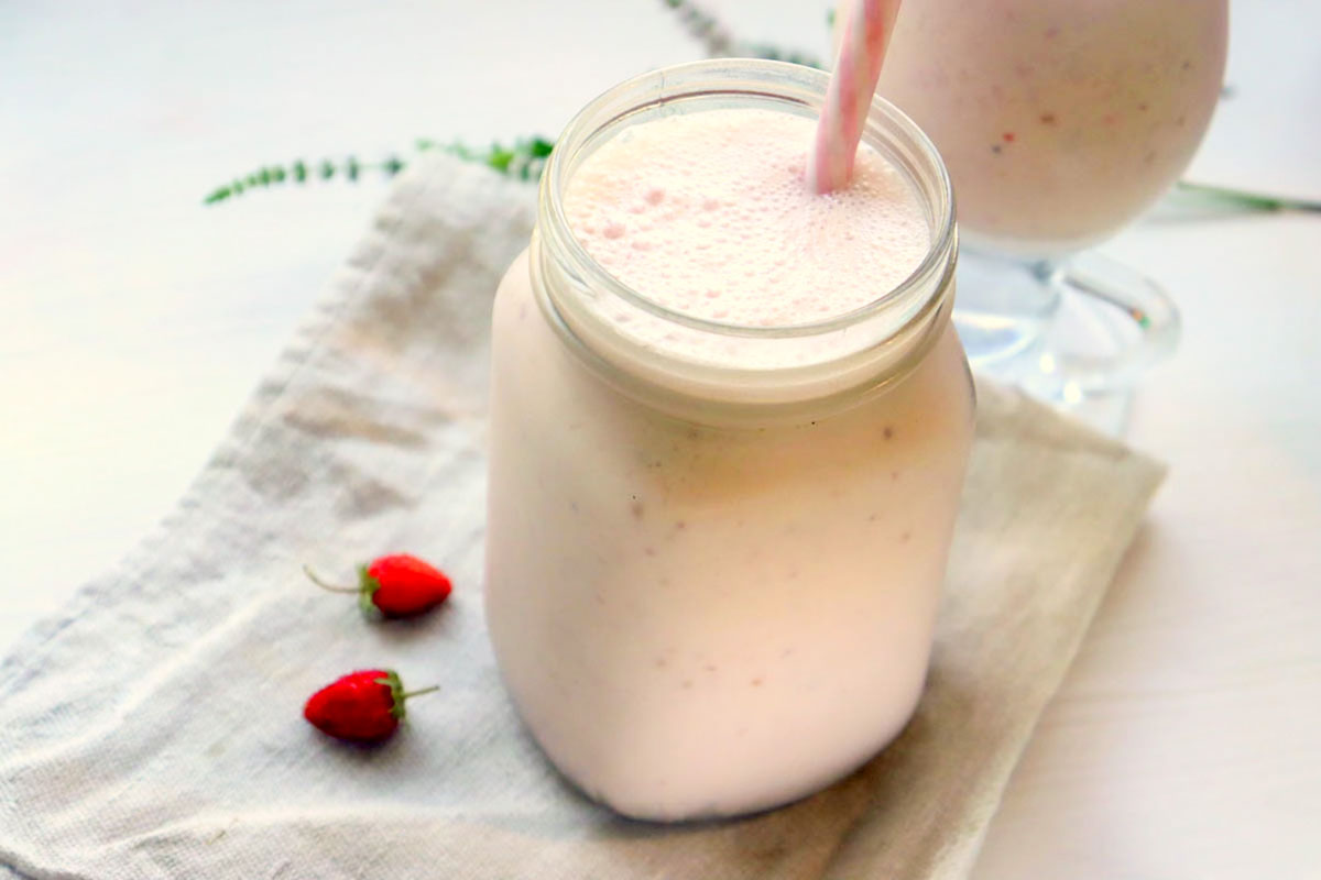 Smoothie in a glass set on a kitchen towel.