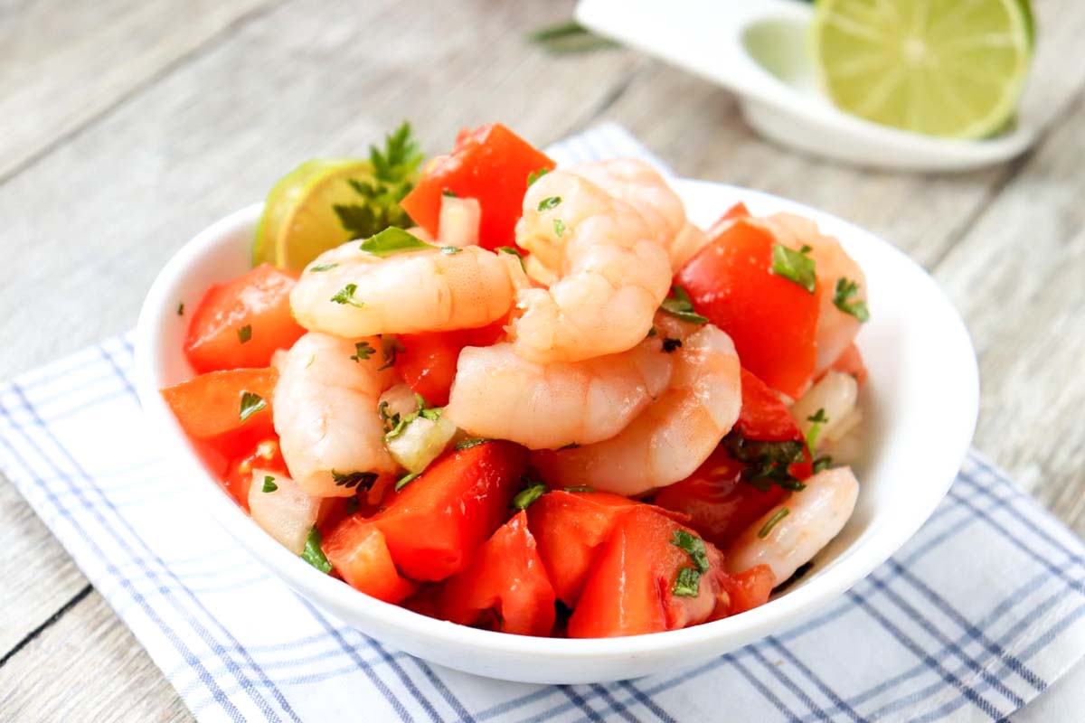 Ceviche in a bowl set on a kitchen towel.