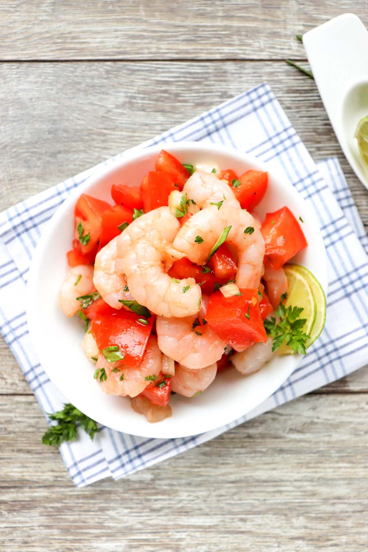 Shrimp ceviche with lime wedges on the side.