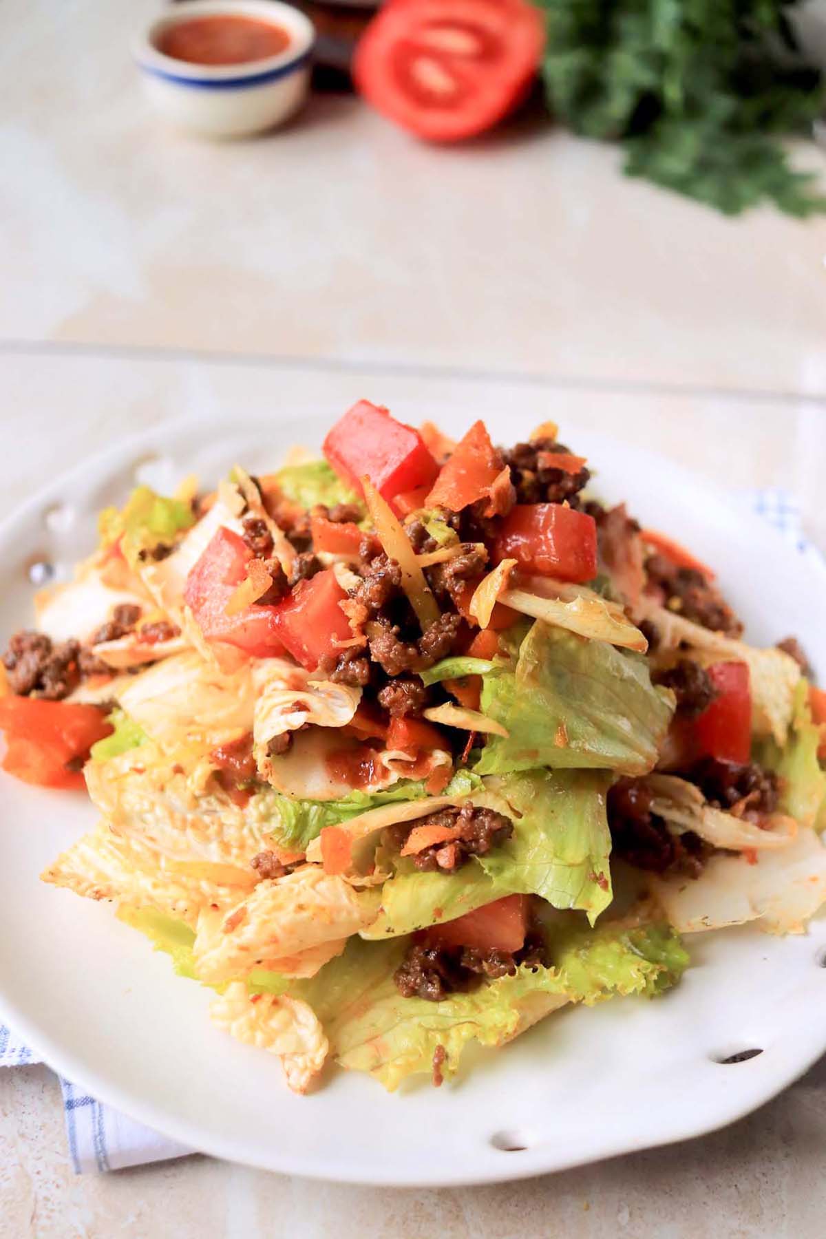 Doritos taco salad on a white plate.