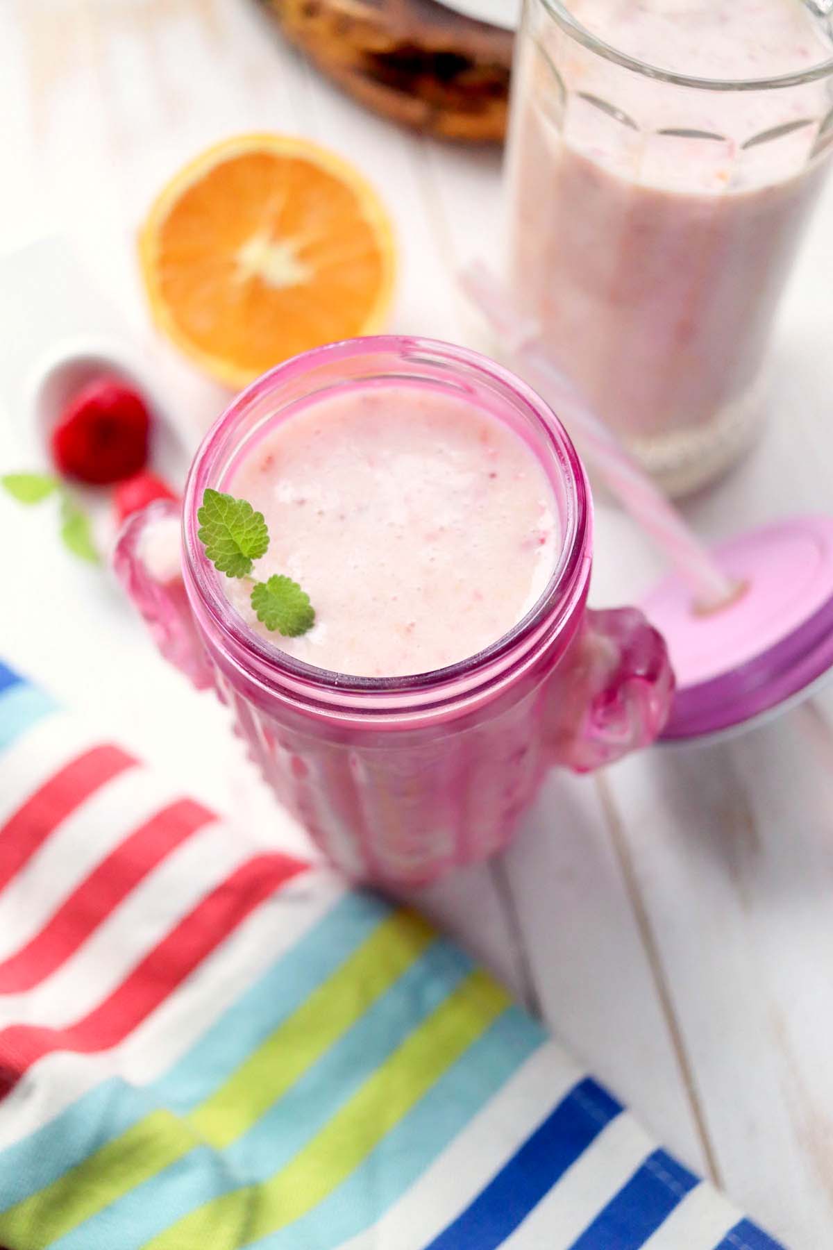 fruit smoothie in pink cup.