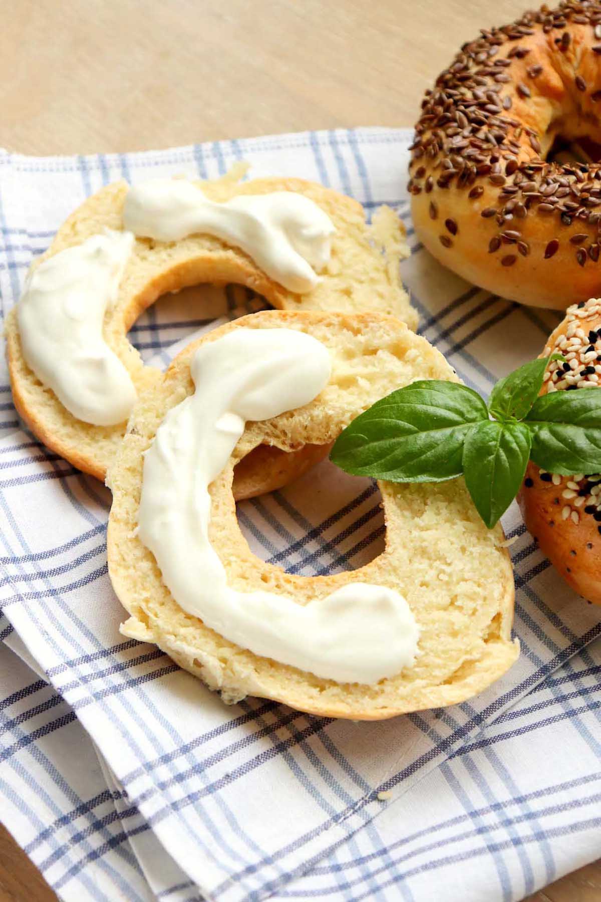 A bagel cut in half with cream cheese.