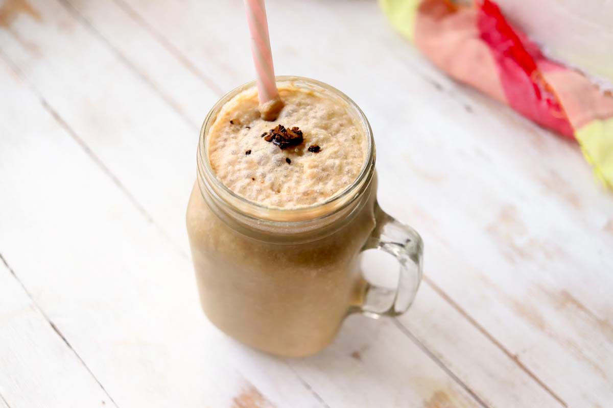 Chocolate shake in a jar with a straw.