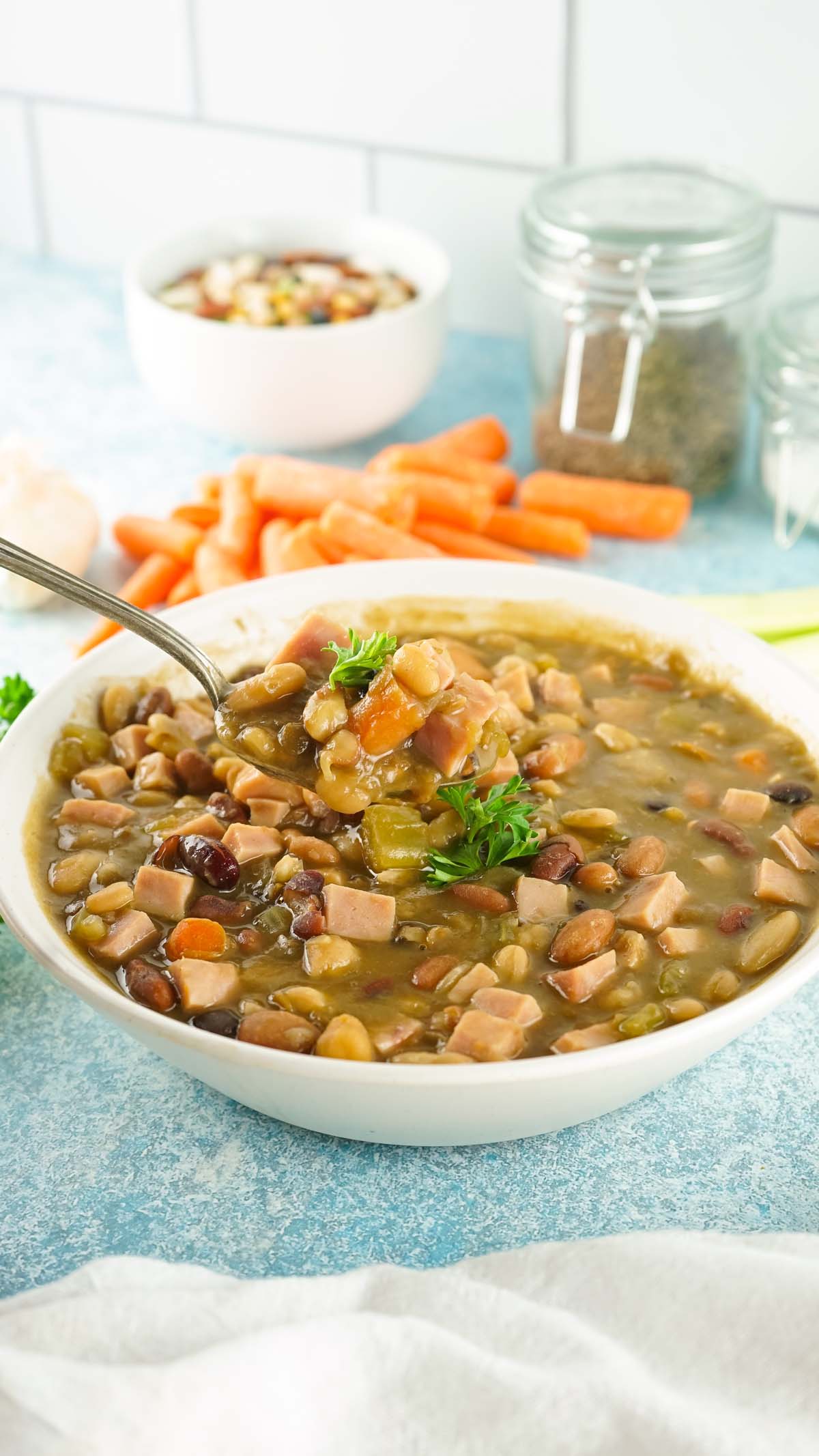 Soup in a bowl and soup scooped on a spoon.