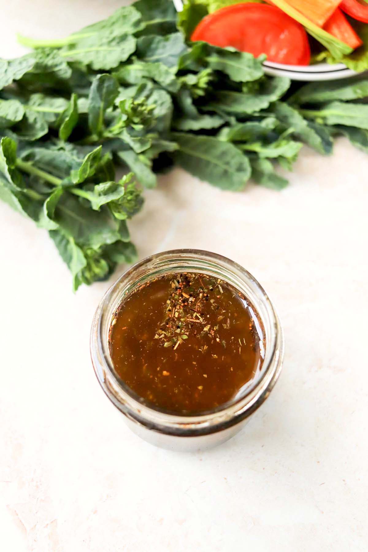 Dressing in a jar topped with dried herbs.