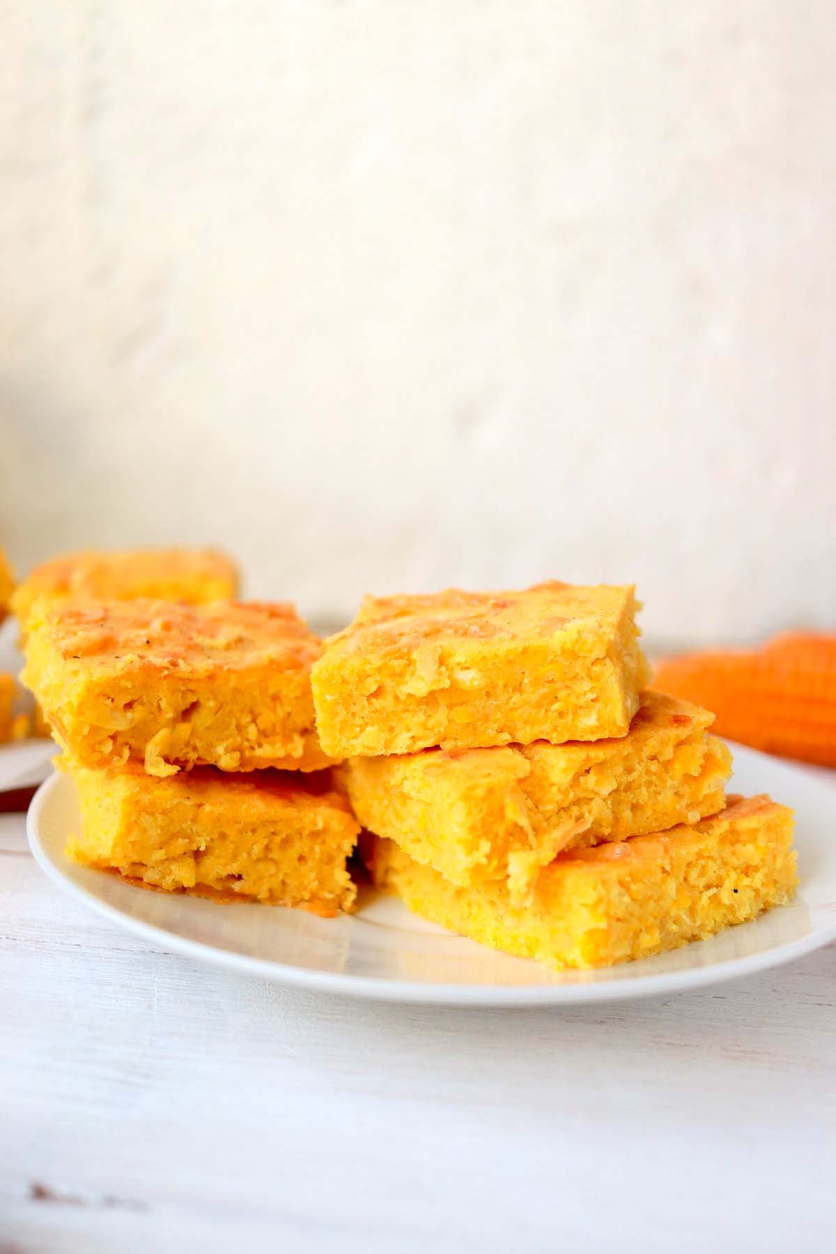 Corn bread stacked on a plate.