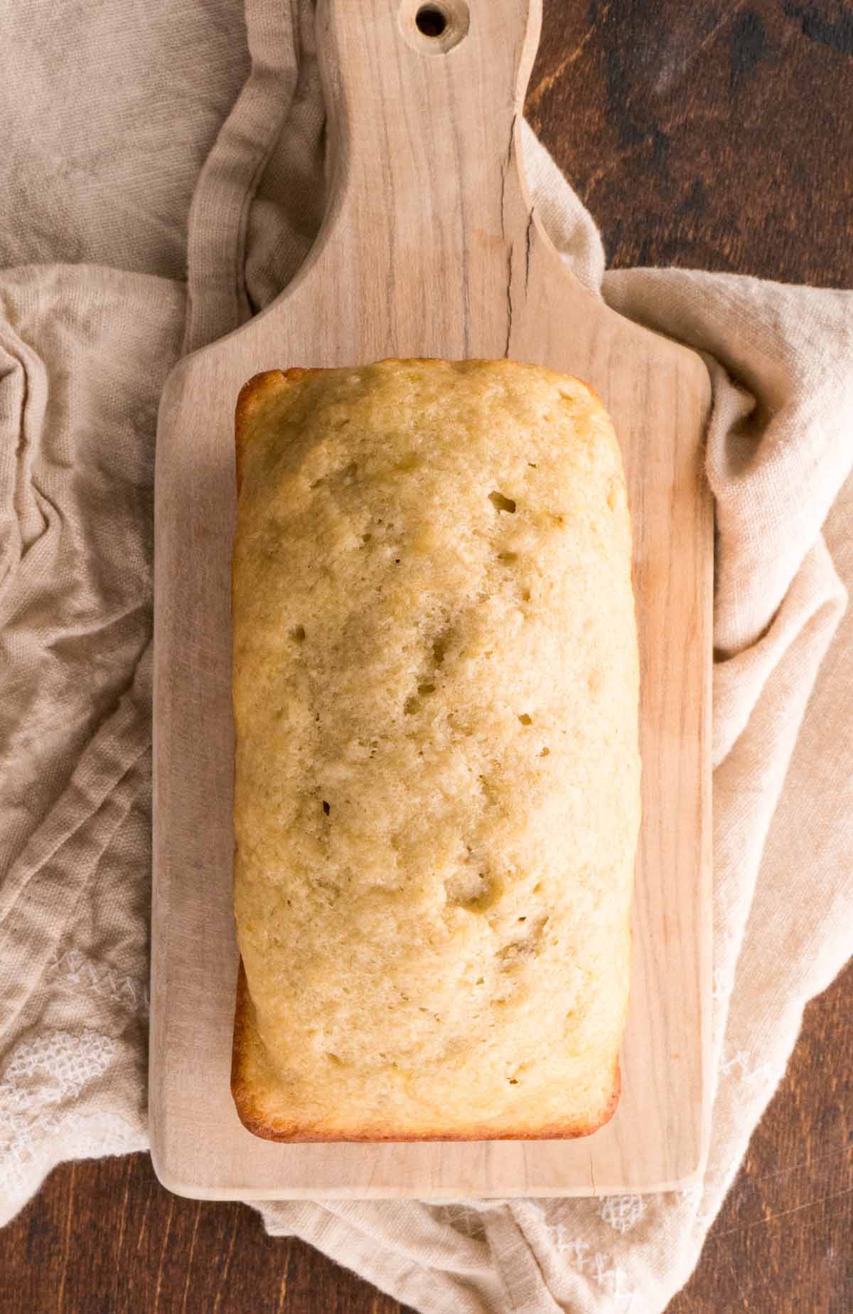 loaf of banana bread on a cutting board.