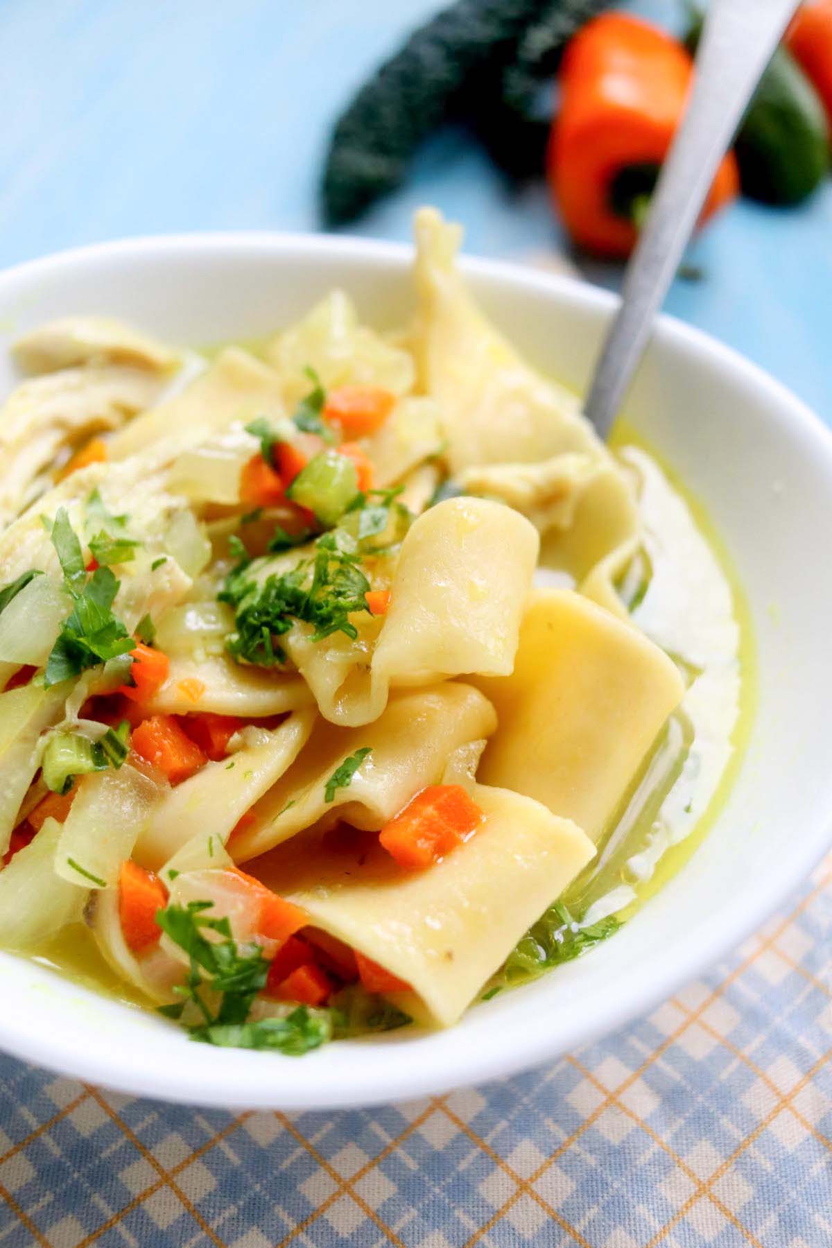 Soup in a bowl with a spoon inside.