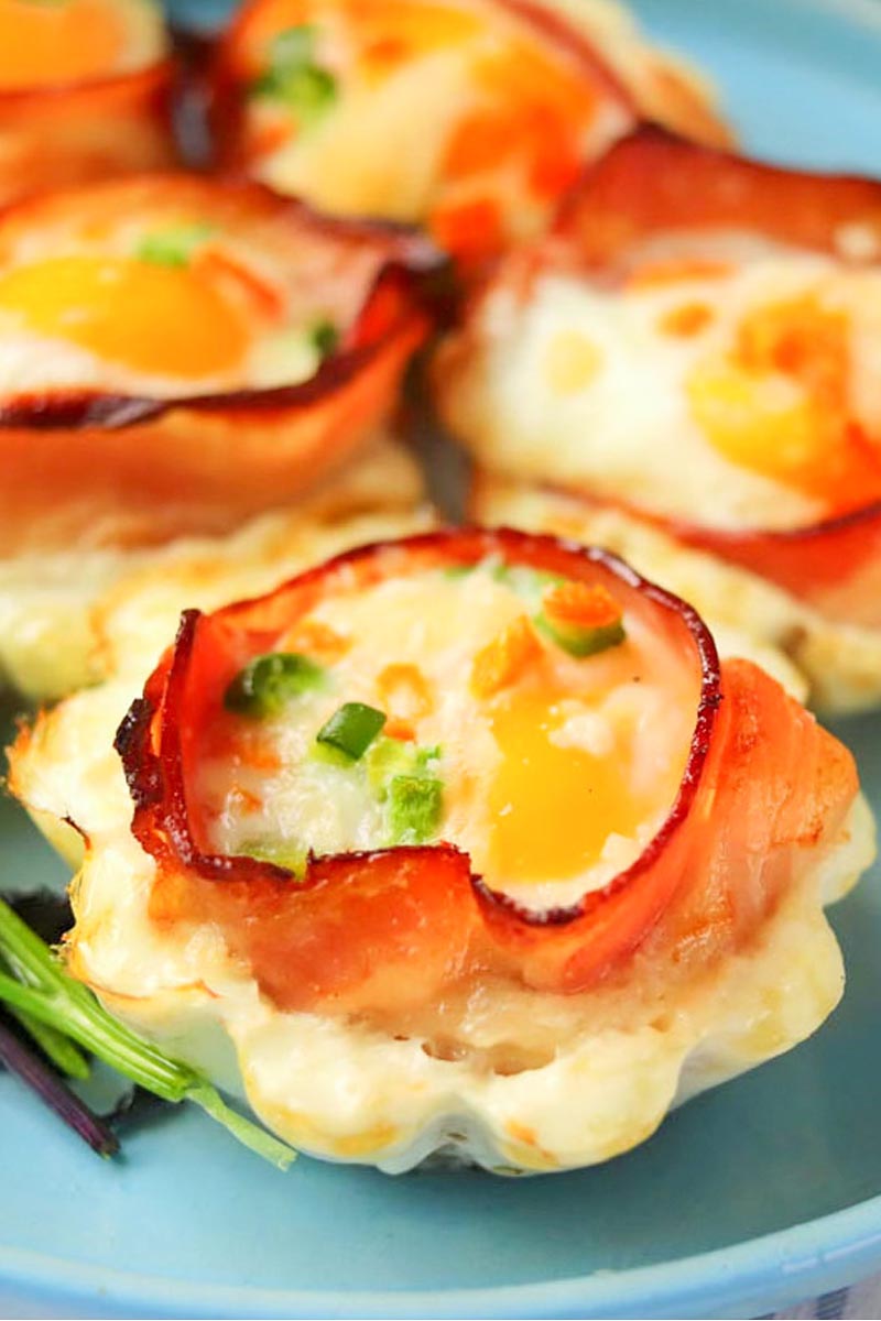 Bacon and egg cups on a plate.