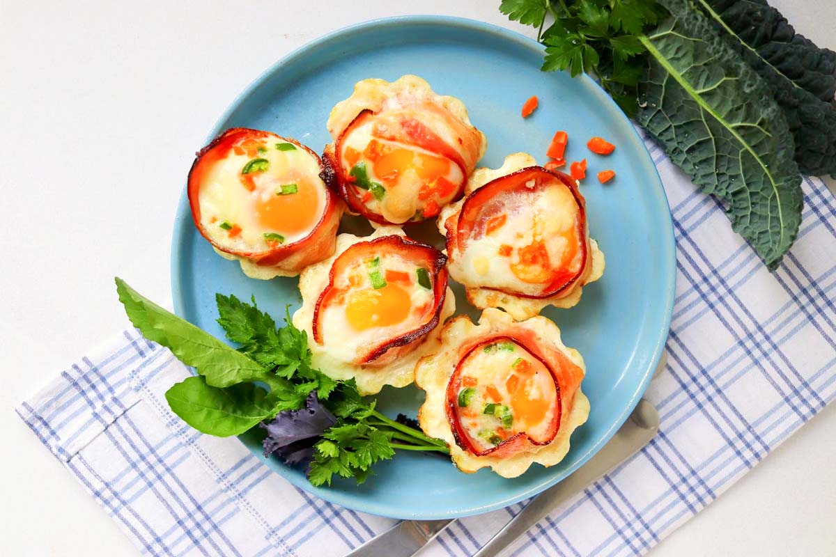 five egg cups on a plate.