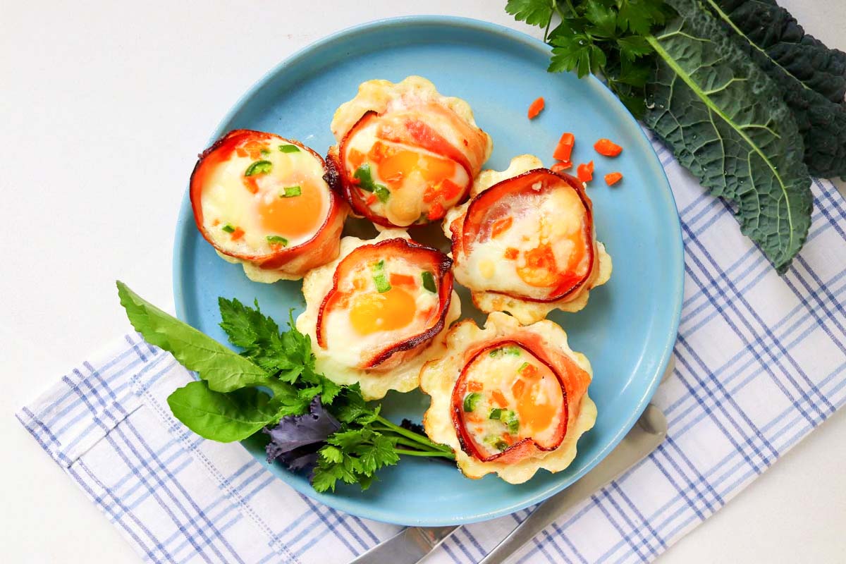 Five egg cups on a blue plate.