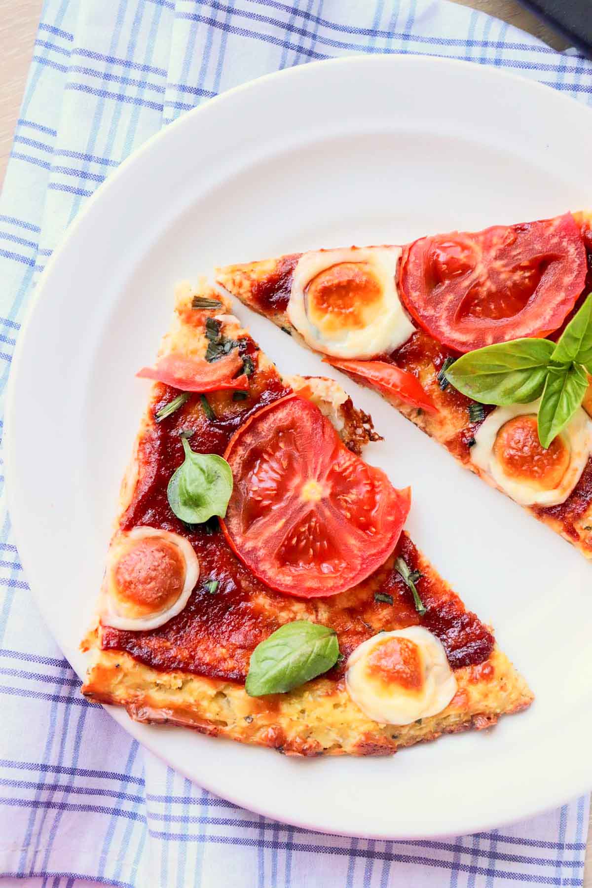 Two slices of pizza on a white plate.