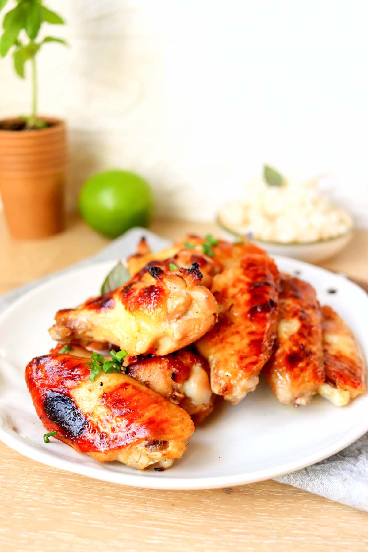 Chicken wings on a white plate.