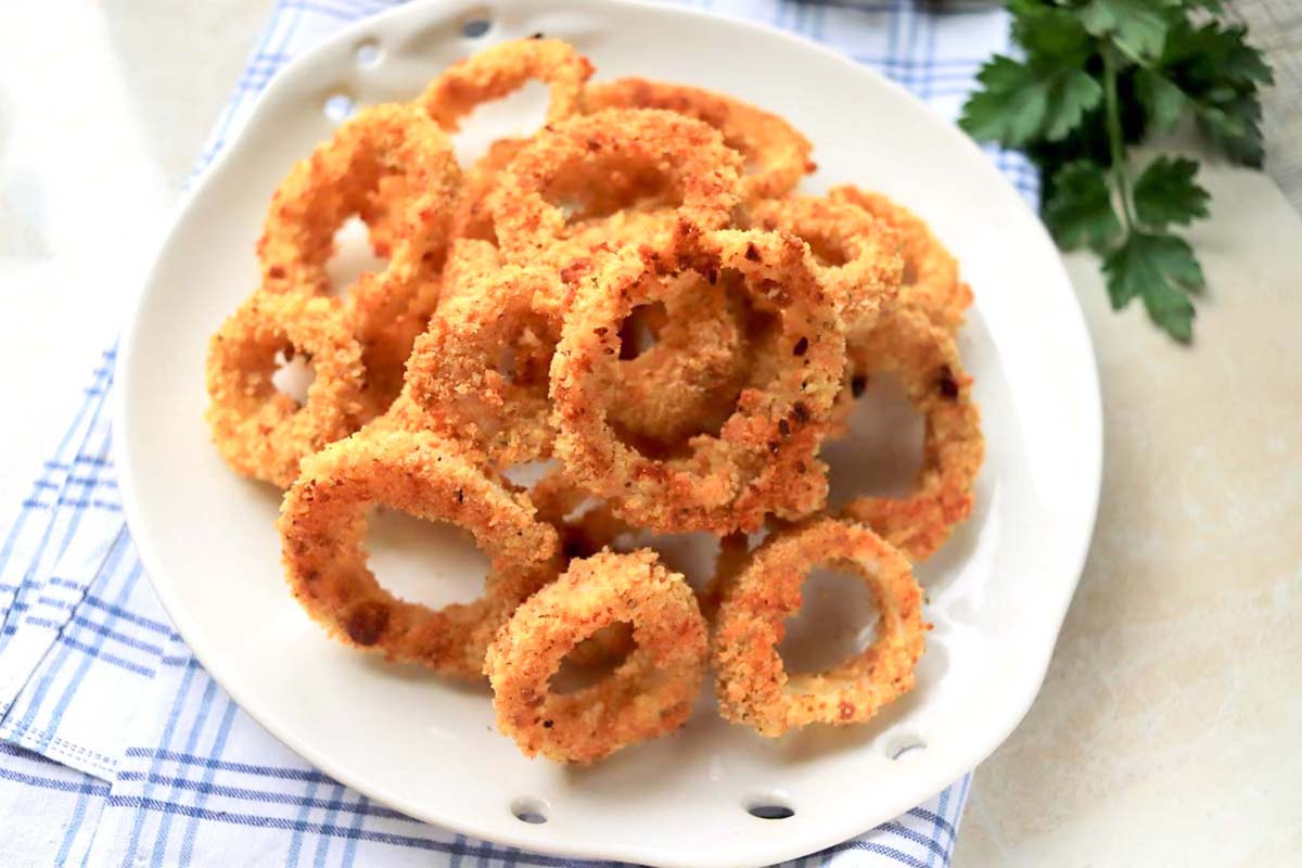 Onion rings on a white plate.