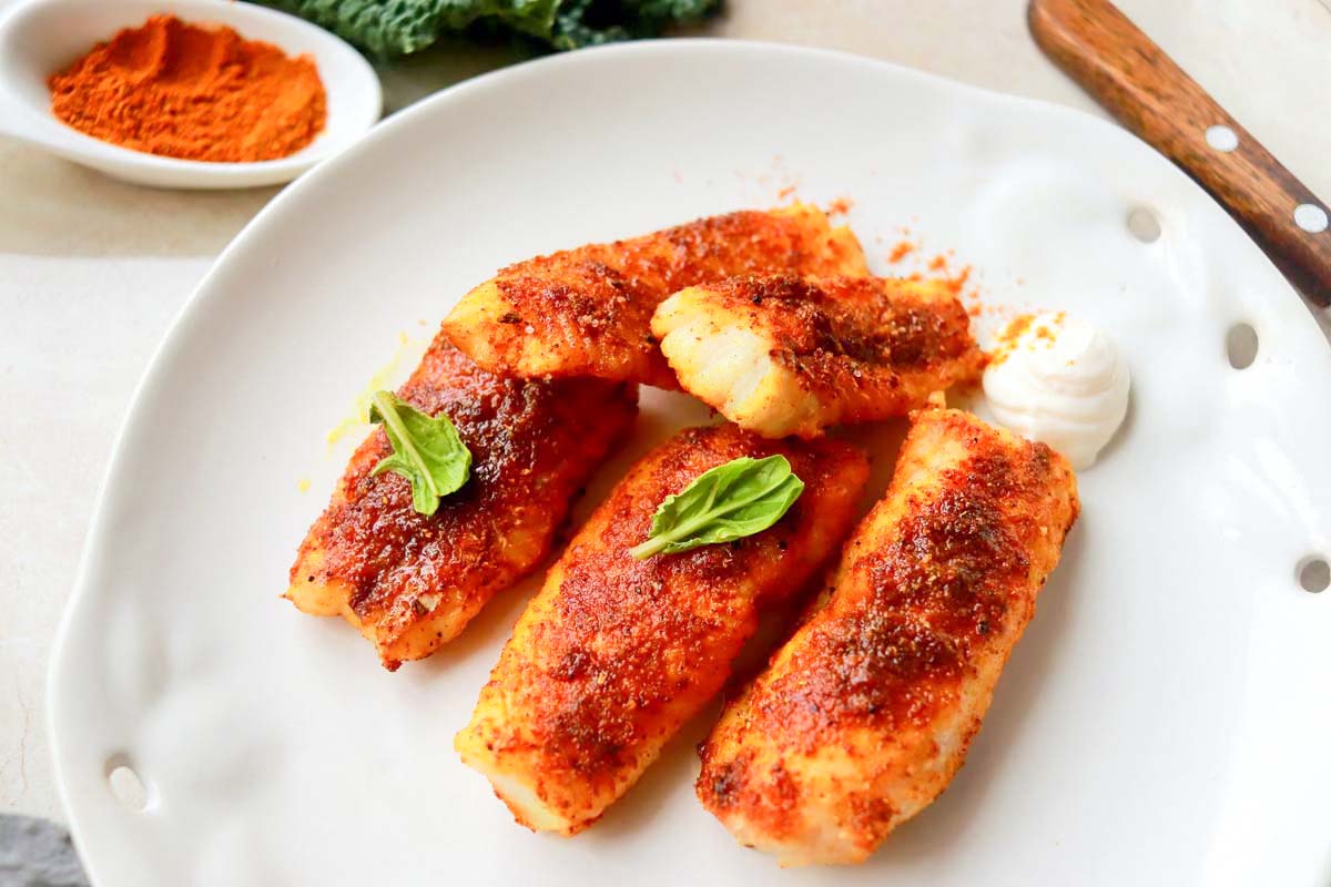 Fish strips on a white plate.