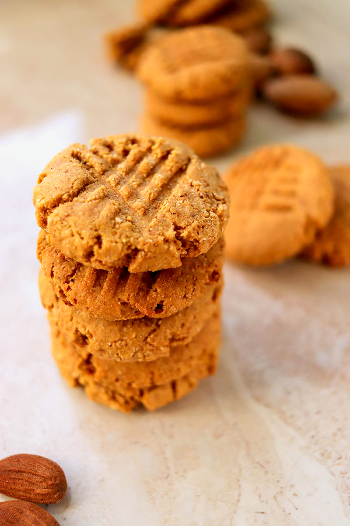 peanut butter cookies stacked on a table.