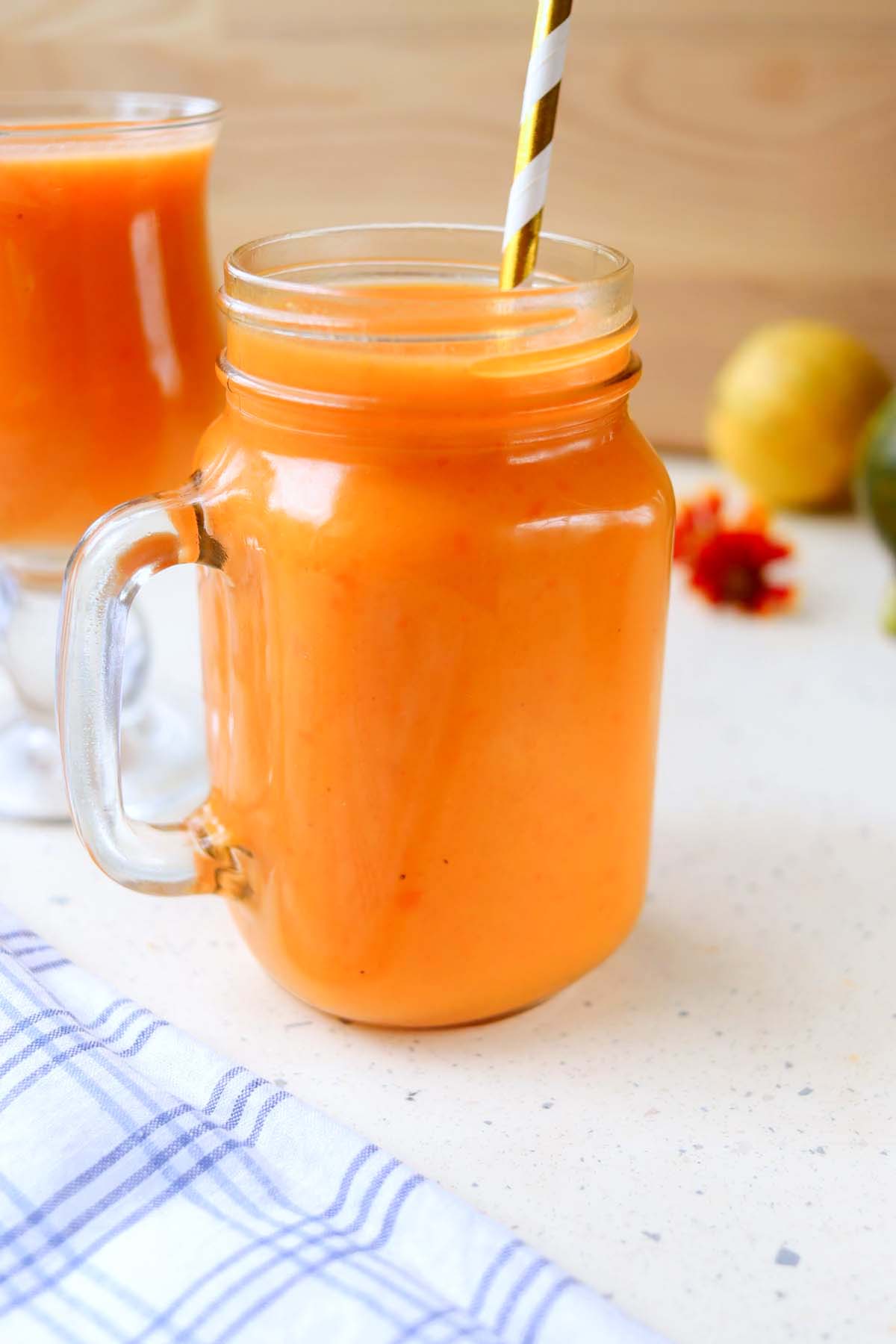 Smoothie in a jar on a white table.