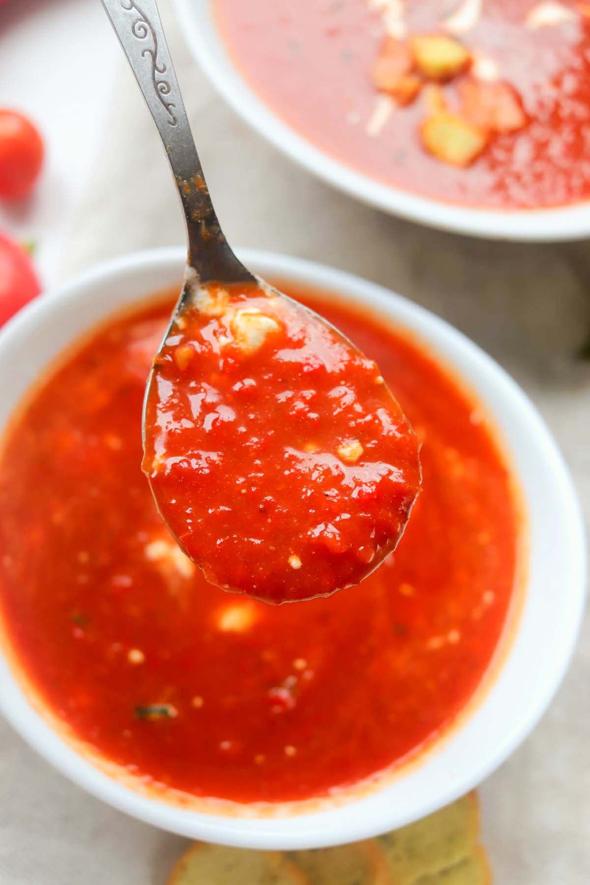 Tomato soup on a spoon.