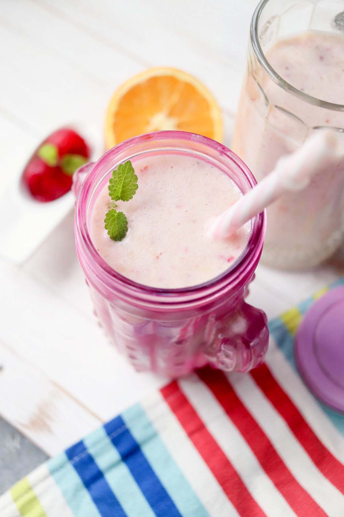 Fruit smoothie in a pink glass.