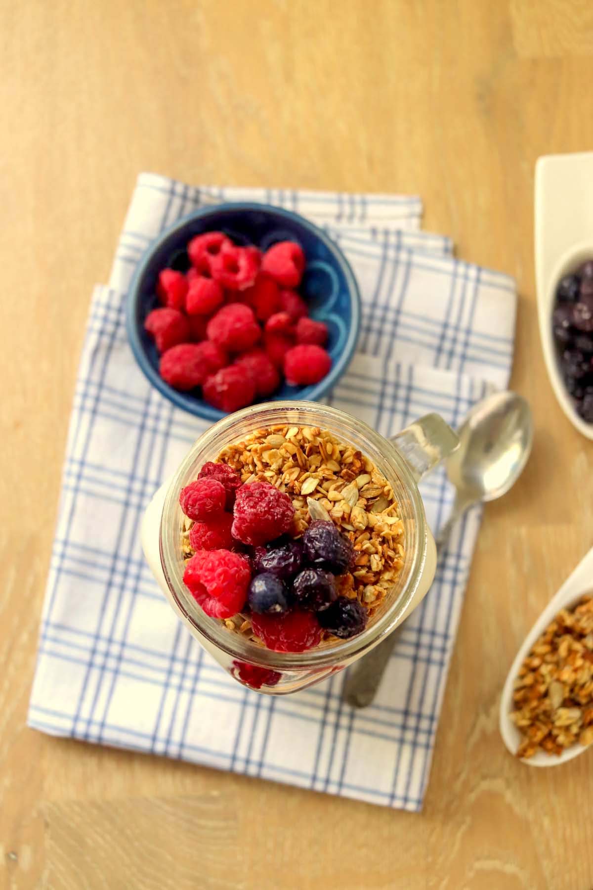 Parfait in a glass set on a kitchen towel.