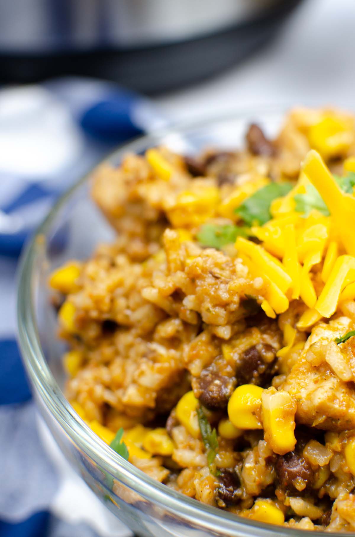 Cooked chicken and rice in a glass bowl.