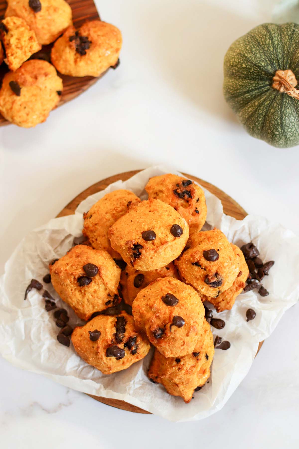 pumpkin cookies stacked on a platter.