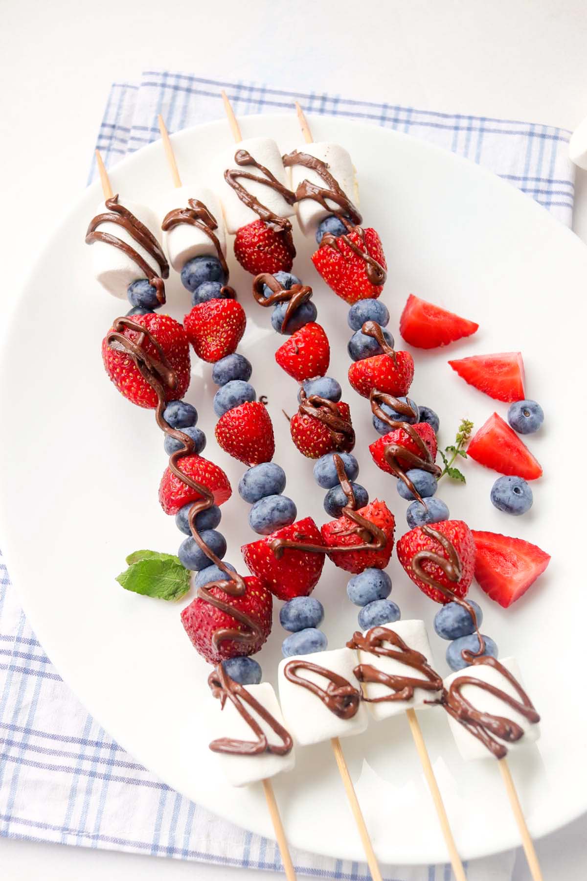 Fruit kabobs drizzled with chocolate.