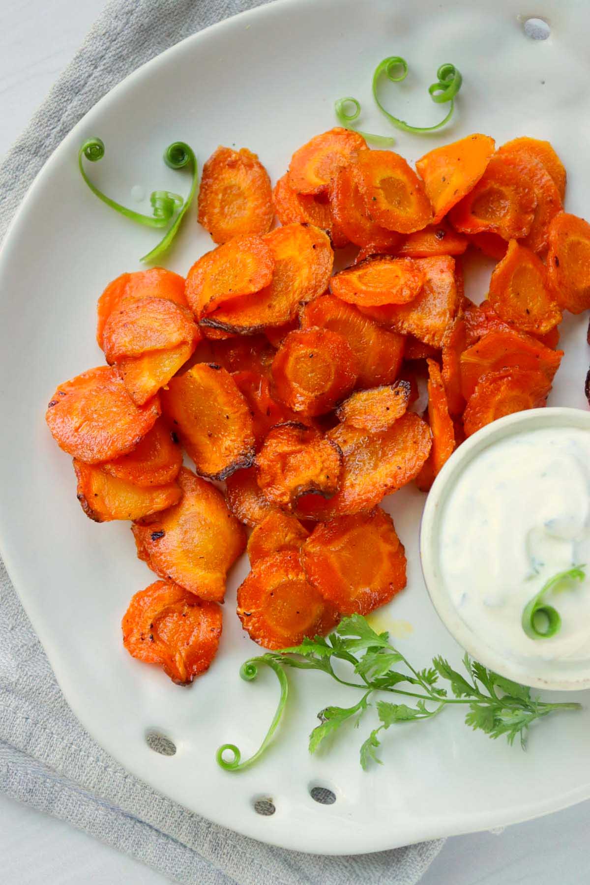 air fried carrot chips on a plate with ranch dip.