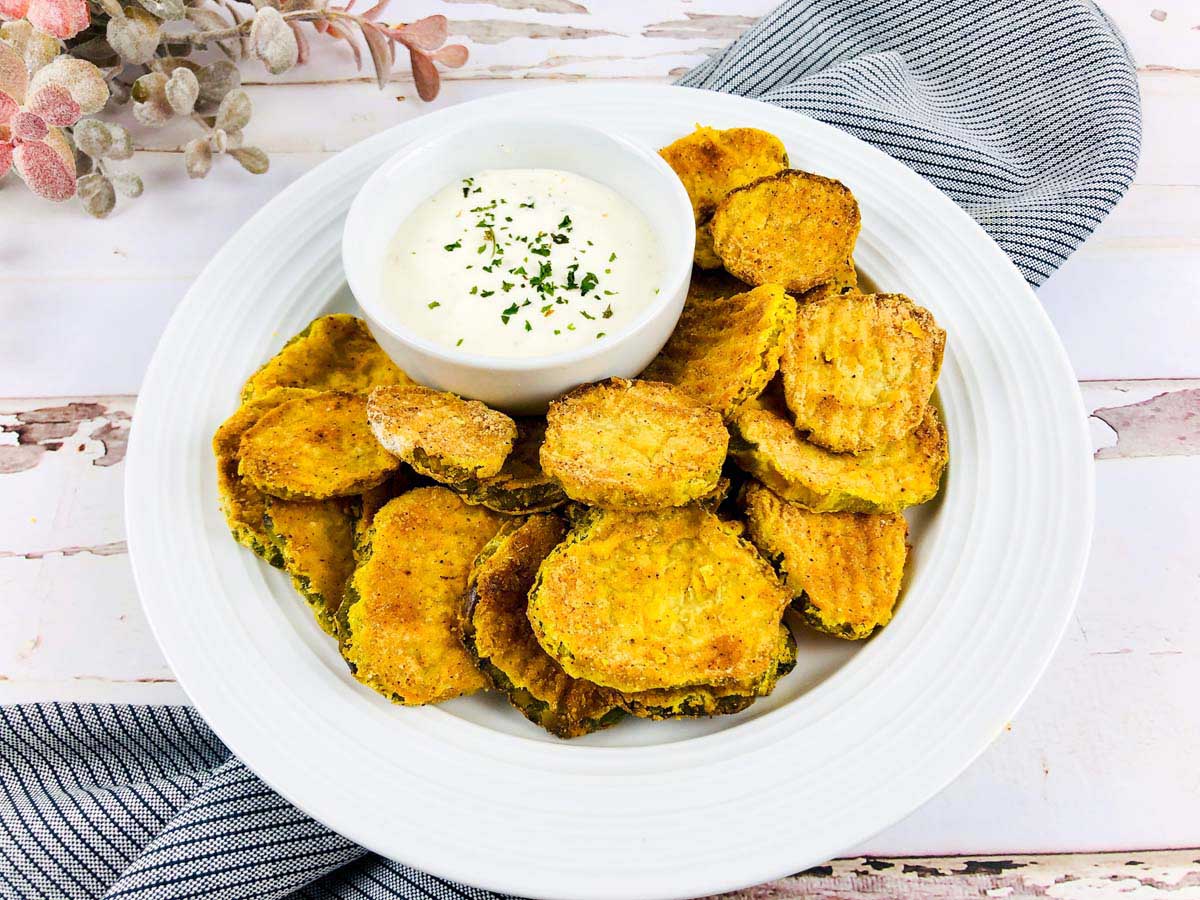 Plate of cooked pickles set on a kitchen towel.